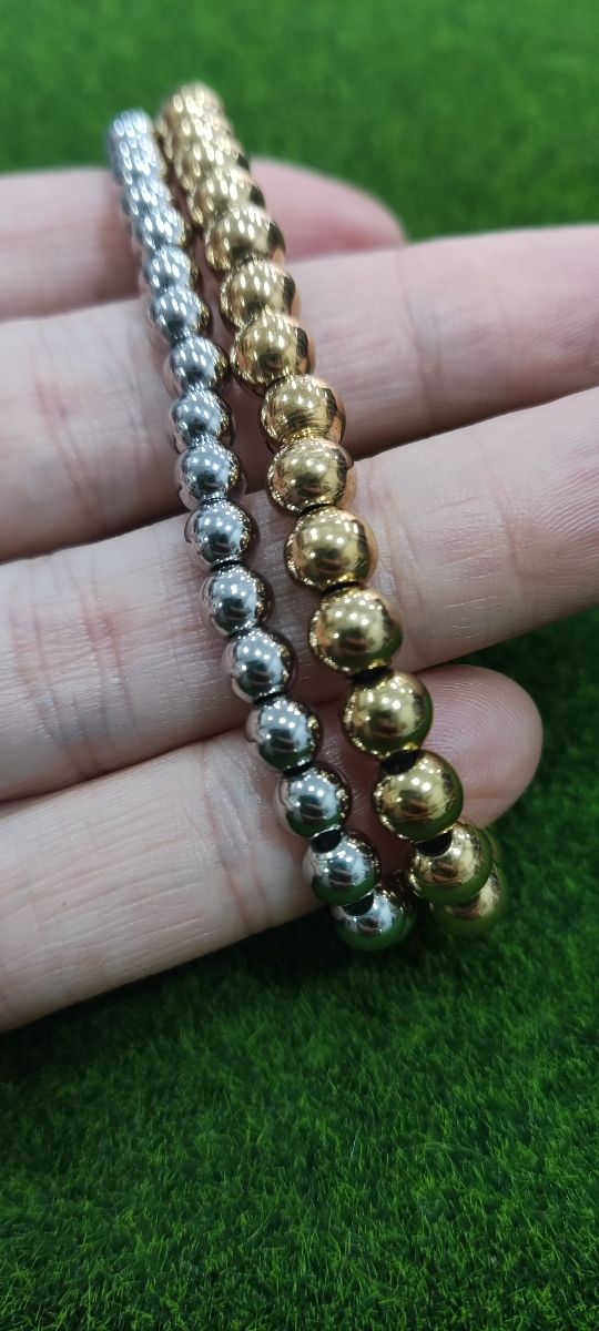 Pulseras bolas acero: oro y plata