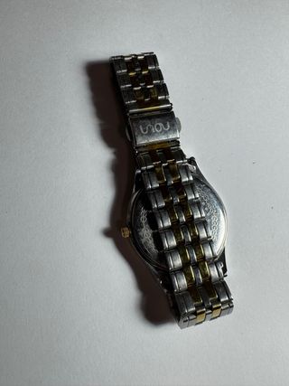 Reloj Noun dorado y plateado