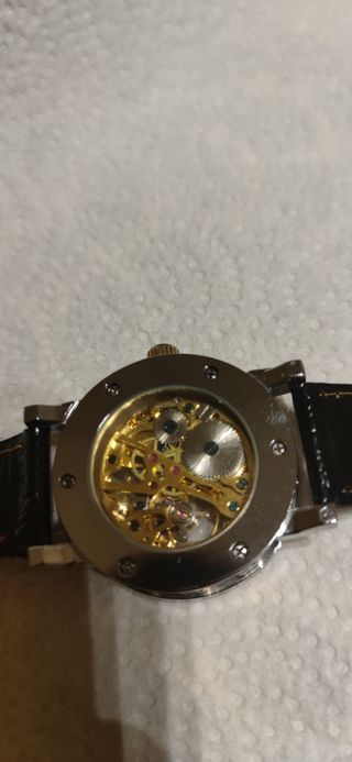 Reloj esqueleto dorado y plateado