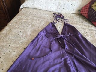 Mono de raso morado. Atado al cuello con tirantes.
