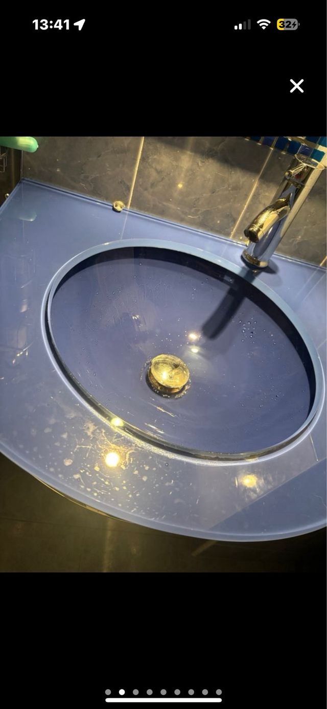 Lavabo azul de cristal con grifo