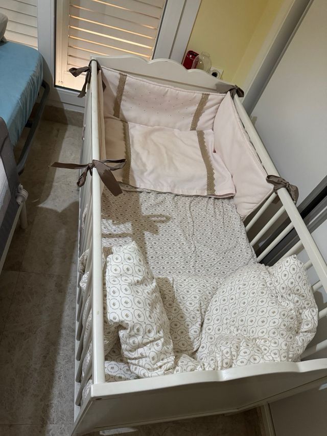 Cuna blanca con textiles.