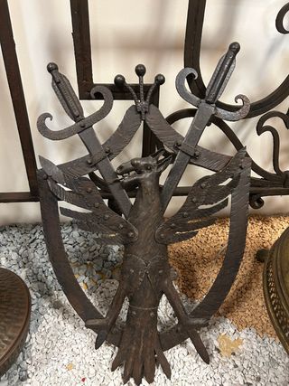 Fregio in metallo con aquila e spade
