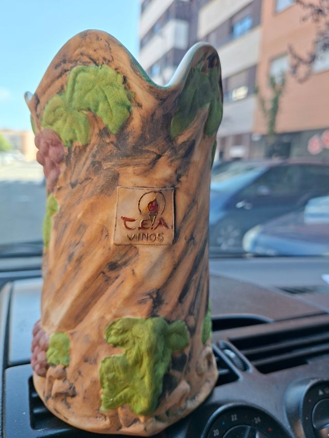 Jarra de vino de biscuit con uvas