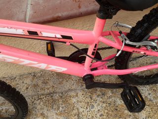 Bicicleta infantil rosa con casco