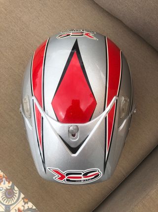 Casco de moto plateado con detalles rojos