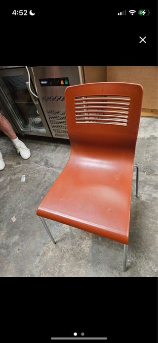 Sillas de plástico naranja y metal plateado