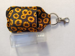 Wb.Estrena.Llavero girasoles con bote recargable..