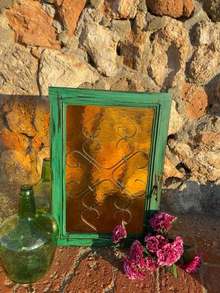 Puerta vintage verde madera, forja y cristal ámbar