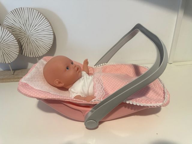 Muñeca bebé en moisés rosa