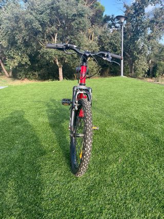 Bicicleta infantil roja de doble suspensión. 