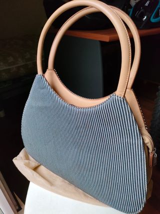 Bolso de tela con rayas y asas de piel.