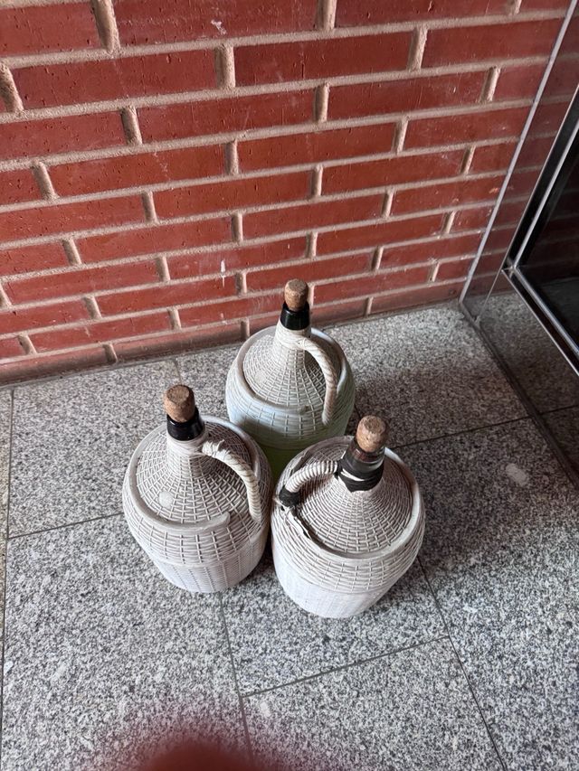 Garrafas de cristal con cestas de mimbre plástica