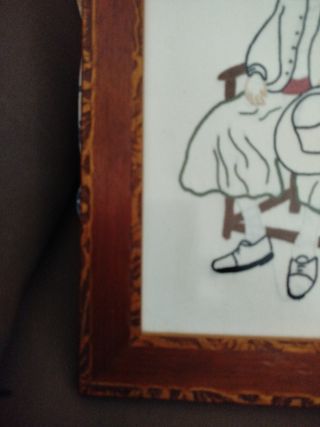 Cuadro bordado de persona sentada