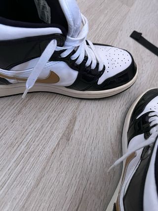 Zapatilla Jordan 1 Mid Negra, Blanca y Dorada