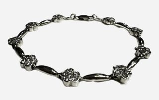 Pulsera semirígida flores circonitas de oro blanco 18K