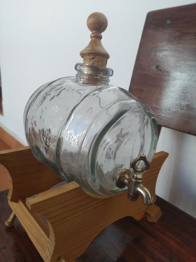 Barril de cristal con grifo y base de madera