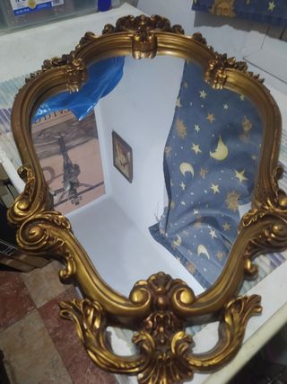 Espejo de pared dorado con marco ornamentado