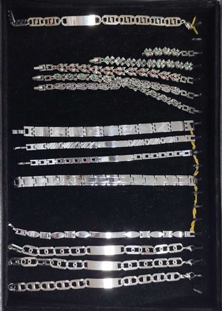 Pulseras plateadas con detalles verdes y rojos