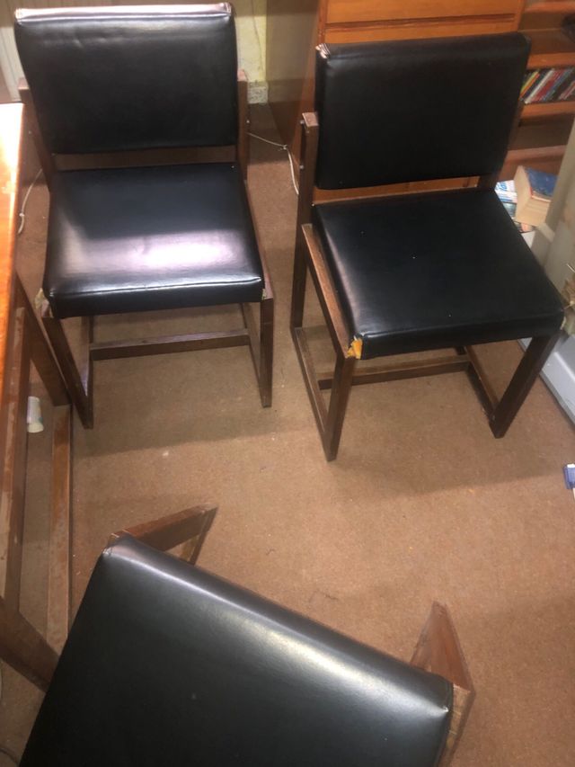 Sillas de comedor negras de cuero.
