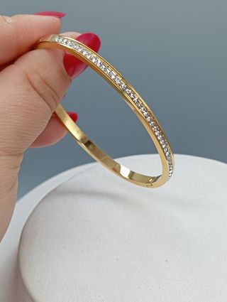 Pulsera rígida acero,baño de oro y circonitas
