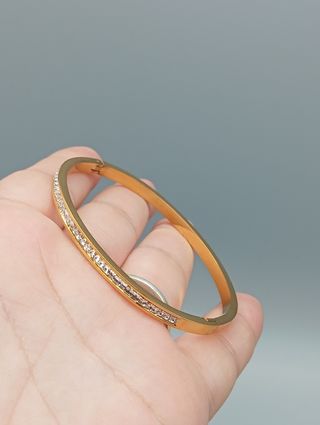 Pulsera rígida acero,baño de oro y circonitas