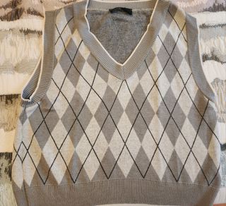 Chaleco de punto gris y blanco.