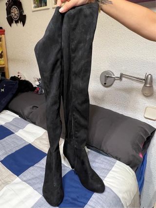 Botas altas negras por encima de la rodilla