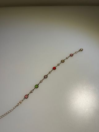 Pulsera dorada con detalles verdes