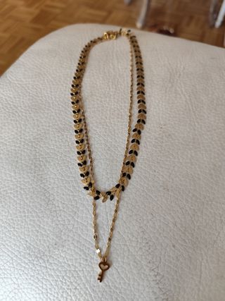 Collar de acero dorado y negro