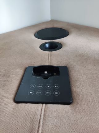 Sofá esquinero beige con sistema de audio