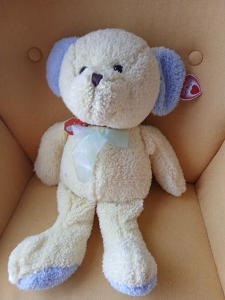 Orsetto di peluche beige con orecchie blu
