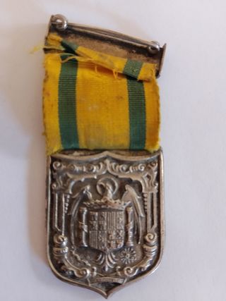 Medalla antigua con escudo y cinta