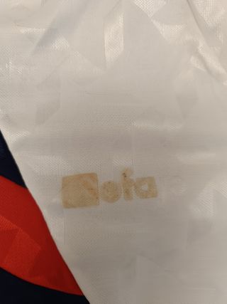 Casaca o remera blanca con detalles rojos y azules