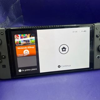Nintendo Switch OLED + Custodia Joy-Con Gioco