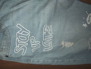 Jeans Terra strappati con scritte