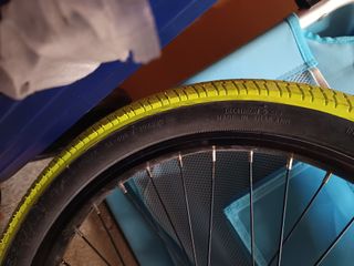 Bici BMX plateada con ruedas amarillas