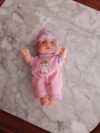 Muñeca bebé rosa con unicornio
