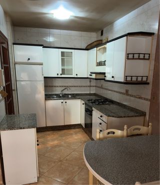 Muebles de cocina blancos y encimera granito negra