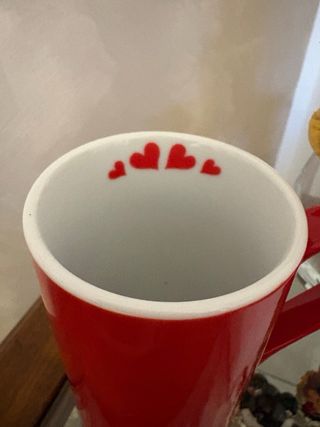 Tazza rossa con cuori bianchi
