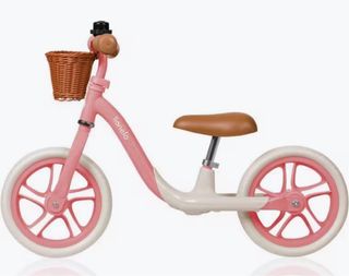 Bicicleta sin pedales rosa con cesta