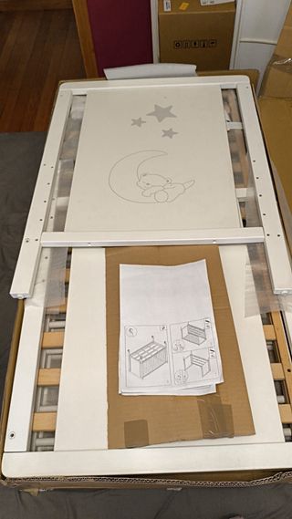 Cuna de bebé blanca con osito y estrellas