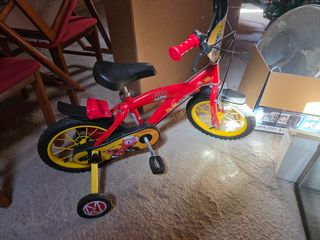 Bicicleta infantil roja con ruedas de apoyo