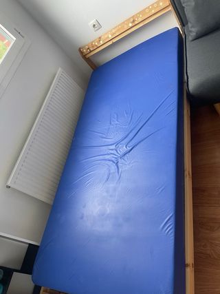 Cama de madera con colchón azul