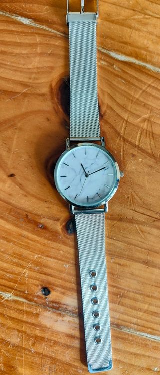 Reloj plateado con esfera blanca