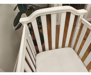 Cuna de madera blanca con ruedas