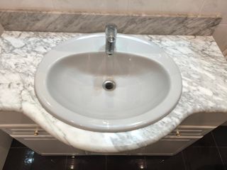 Encimera  de mármol y lavabo sin grifo.