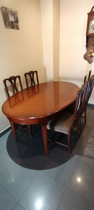 Mueble de salón madera oscura y mesa con sillas
