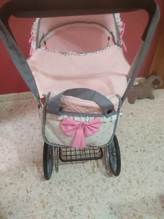 Carro de muñecas rosa con lazo