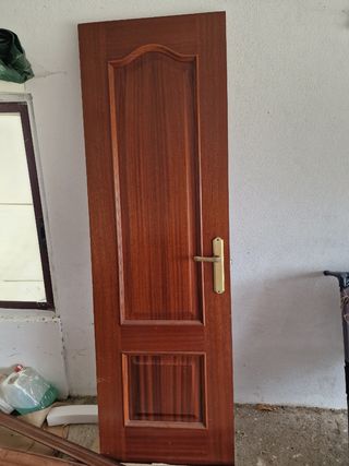 Puerta de madera con manilla dorada
